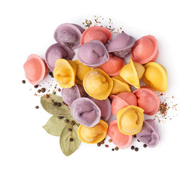 Colorful raw dumplings with peppercorn and bay leaves on white background