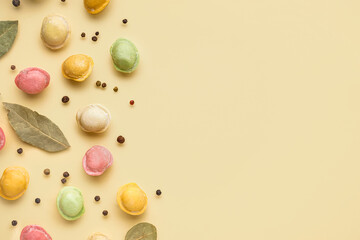 Colorful raw dumplings with peppercorn and bay leaves on yellow background