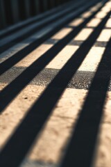 A detailed view of a bench with shadows cast upon it. Perfect for depicting solitude or relaxation in outdoor settings