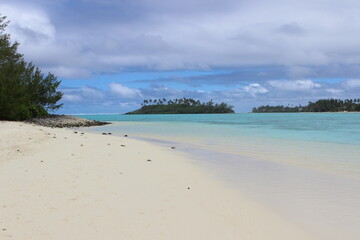 rarotonga clear water sky turquoise white beach cloudy sky