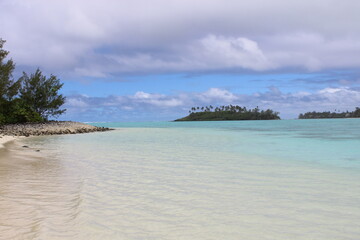 rarotonga clear water sky turquoise white beach cloudy sky