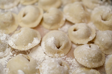 A pile of dumplings with flour on the table
