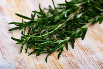 Image of rosemary on wooden background, top view