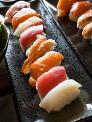Nigiri sushi on black plate. Japanese food.