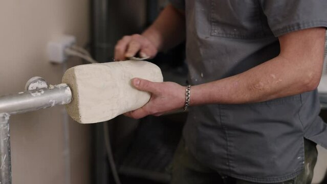 Prosthetic innovation, Hip disarticulation, Mold creation. Streamlined mold for hip disarticulation prosthetic leg being made by man, achieved by discarding unnecessary parts.