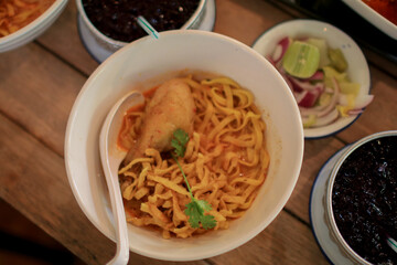 Khao Soi with chicken. Northern of Thailand Style Curry Noodle Soup with Chicken and seasoning. Spicy food.