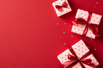 Valentine's Day. Frame of festive gift boxes on red background. View from above. Flat lay.