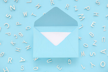 Open envelope with scattered letters on blue background