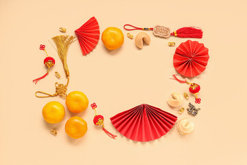 Frame made of fortune cookies with mandarins and Chinese symbols on beige background. New Year celebration