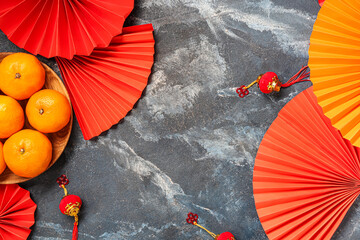 Mandarins with Chinese symbols on blue grunge background. New Year celebration