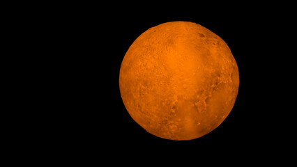 Lamp in the shape of a full moon, orange-yellow, with a rough surface. on a black background