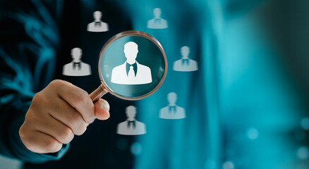 Human Resources Manager using magnifier glass finding with human icons, HRM, CRM, Recruitment...
