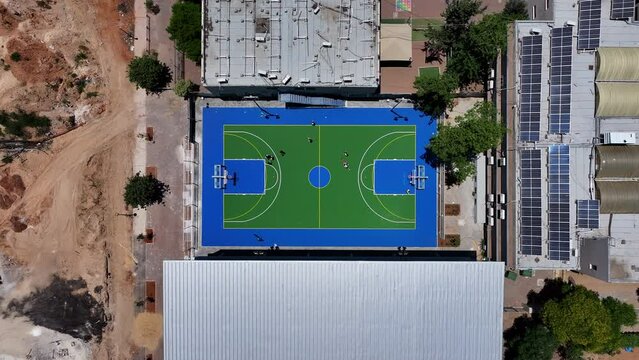 Aerial Top Lockdown Shot Of People Playing In Basketball Court On Sunny Day - Holon, Israel