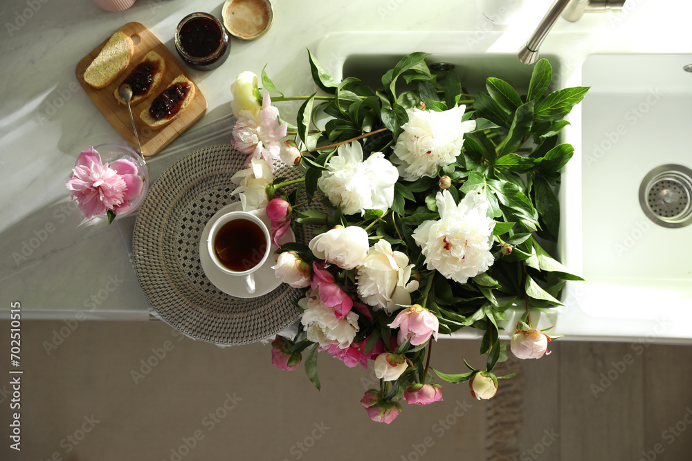 Canvas Prints Beautiful peonies and breakfast on kitchen counter, flat lay