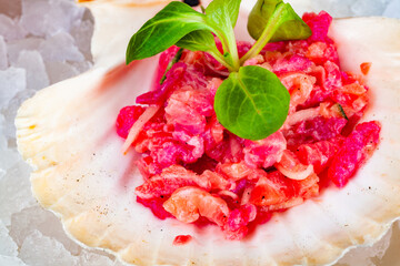 Ceviche. Finely chopped raw tuna and salmon marinated in lemon juice served in seashell.