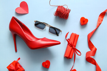 Composition with stylish female shoe, sunglasses and gifts for Valentine's Day celebration on color background