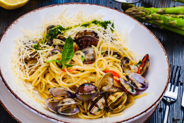 Italian food. Seafood pasta with clams. Spaghetti alle Vongole on white plate.