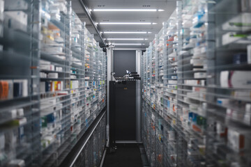 Narrow pharmacy aisle flanked by towering shelves stocked with medicine boxes. A pharmacy robot...