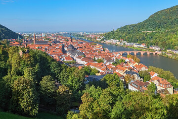 Heidelberg, Germany. High angle view over the Heidelberg Old Town with Jesuit Church, Church of the Holy Spirit and Old Bridge (Karl Theodor Bridge) across the Neckar river. - 702511197