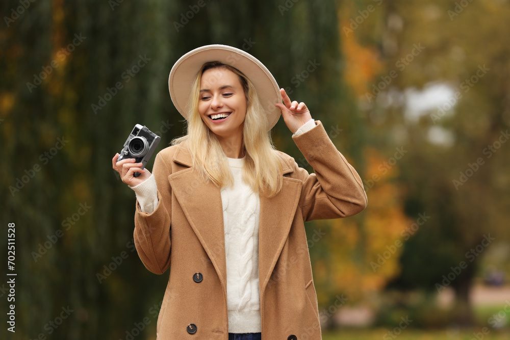 Canvas Prints Portrait of happy woman with camera in autumn park