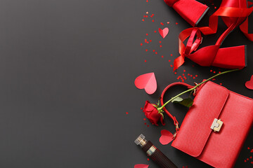 Composition with stylish female handbag, shoes and red rose flower on dark background. Valentine's Day celebration