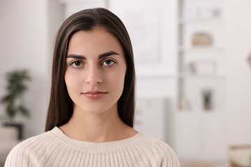 Portrait of beautiful woman indoors, space for text