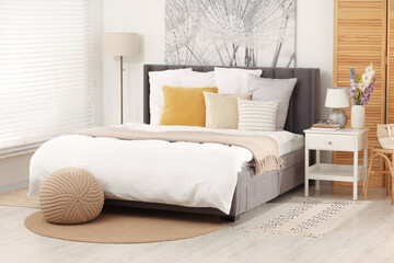 Fototapeta na wymiar Light bedroom interior with comfortable modern bed