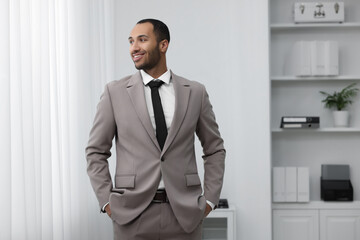 Portrait of smiling young man in office. Lawyer, businessman, accountant or manager