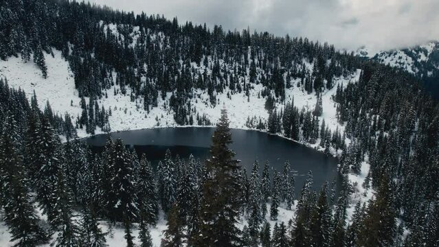First Snow Aerial of Peaceful Mountain Lake