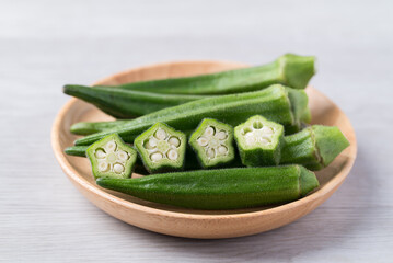Green okra in wooden bowl prepare for cooking, Organic vegetables