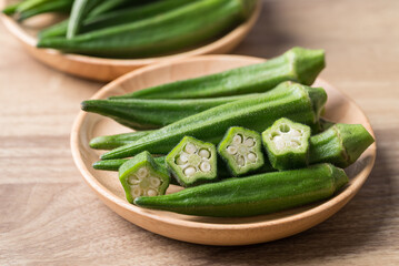 Green okra in wooden bowl prepare for cooking, Organic vegetables