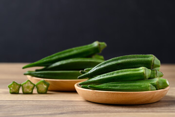 Green okra in wooden bowl prepare for cooking, Organic vegetables