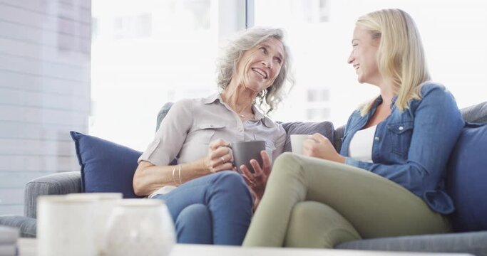 Mother, daughter and coffee talking on sofa for connection discussion, bonding together or home conversation. Senior person, woman and drink for laughing on couch or love rest, relax or communication