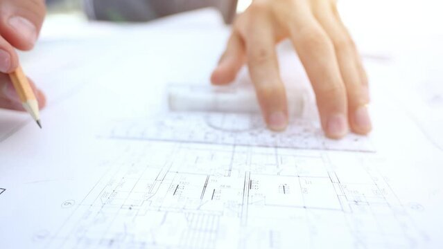 Young handsome architect engineer working on design plan