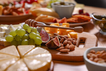 Assorted appetizers served on wooden table, closeup