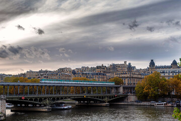 Paris metro train crossing the Bir Hakeim Bridge in Paris, France on a cloudy day