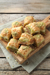 Delicious fresh baklava with chopped nuts on wooden table. Eastern sweets