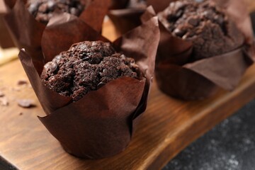 Tasty chocolate muffins on grey table, closeup