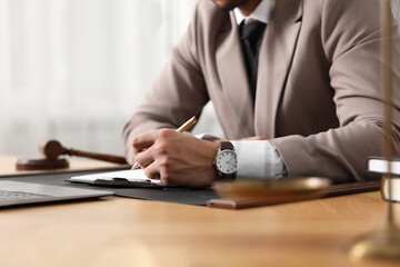 Lawyer working at table in office, closeup