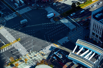 of busy intersection with traffic and people in Toyosu, Tokyo, Japan