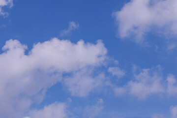 Blue sky with a few white clouds background