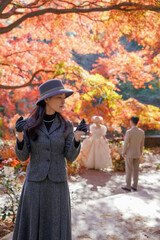 The girl and the old maple tree in the mountains