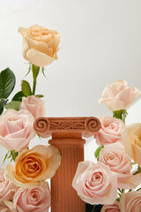 Front view of a wooden pedestal decorated with surrounding roses on a minimalist white background. Empty space for product display. Beauty with fresh flowers.