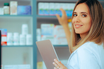 Pharmacist Holding a Pc Tablet Picking Something from a Shelf. Hard working pharmacy employee...