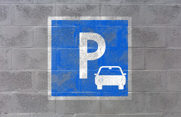 Parking, panneau peint sur mur de parpaings 