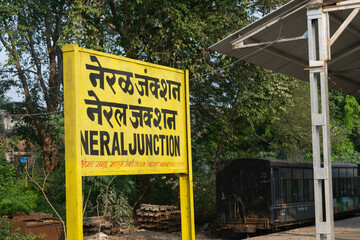 Picture of board of Neral railway station on Matheran toy train route. Local, Mumbai, karjat, lonavala, maharashtra, marathi, hindi, devnagari, Junction, tickets.