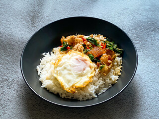 Rice topped with crispy pork belly with Thai basil and fried egg