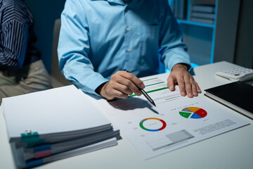 using computer together in office, successful business people working together in a co-working office, two business professionals working on a tech project, business colleagues talking to each other,