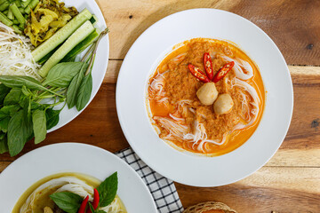 Rice noodles with curry sauce with a boiled egg. Eat with a variety of vegetables for deliciousness. It has a spicy flavor from spices and herbs. (Kanom Jeen Nam Ya)