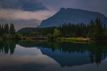 Fototapeta na wymiar Moody Panoramic Mountain Reflections In A Banff Park